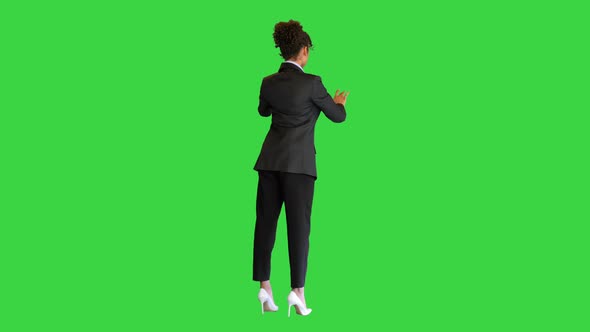 Black Businesswoman Working on a Virtual Board on a Green Screen Chroma Key