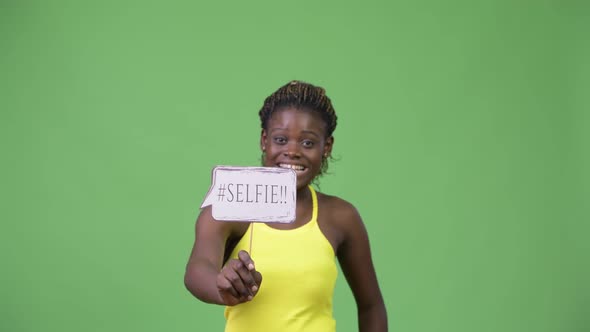 Young African Woman Showing Selfie Paper Sign