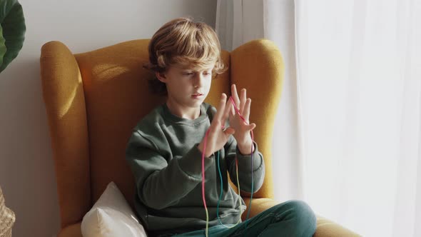 Happy boy enjoying string game at home