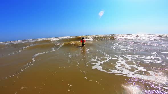 Boy Enjoys in Waves in the Sea