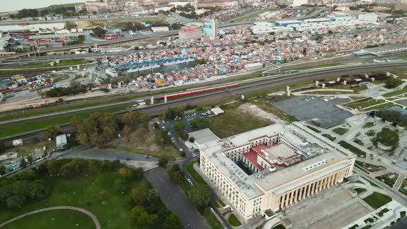 Aerial of a train passing between Faculty of Law and Villa 31 in Buenos Aires, Argentina