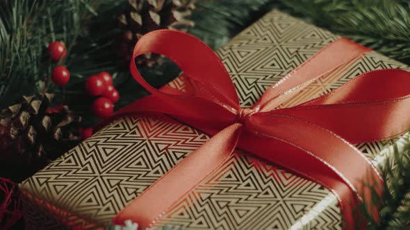 Gold luxury New Year's gift with red ribbon