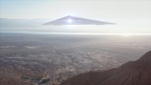 Large Triangle alien ufo over sea and desert mountains-Aerial