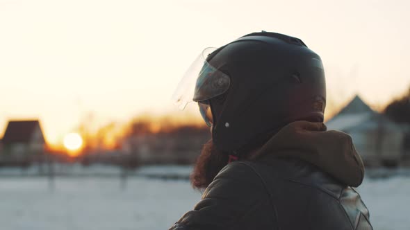 Man Rides a Motorcycle in Cold Winter