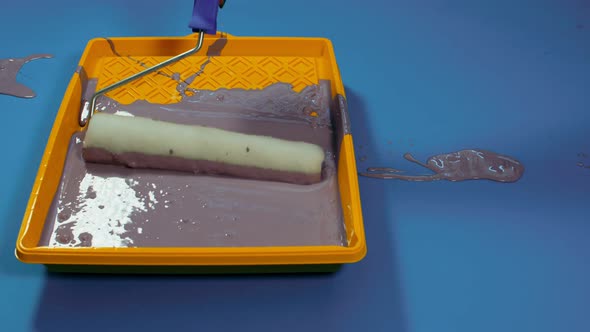 Close Up of Plastic Tray with Gray Paint on Blue Background