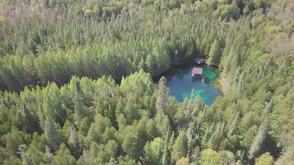 Aerial drone shot flying over crystal blue water of Kitch-iti-kipi, the big spring in Palms Book Sta