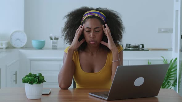 Multitasking African American Woman Entrepreneur Having Headache Due to Computer Stress After Hard