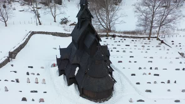 Borgund Stave church from the middle age in Norway - Aerial orbiting while descending and approachin