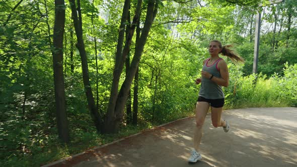 Slow Motion Fit Woman Jogging in Park