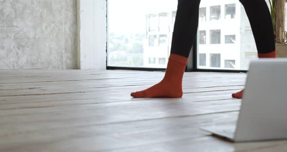 Close Up of Female Legs Body Part in Red Warm Textile Socks Run Across Floor in Room in Cozy Home