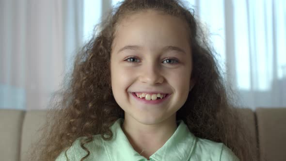 Portrait Honey Little Girl Smiling Child Looking at Camera are Sitting on the Couch at Home Cute Kid