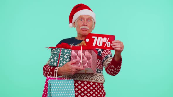 Mature Man in Christmas Sweater Showing Gift Box and 70 Percent Discount Inscriptions Banner Text