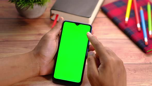 Top View of Man Hand Using Smart Phone on Office Desk 