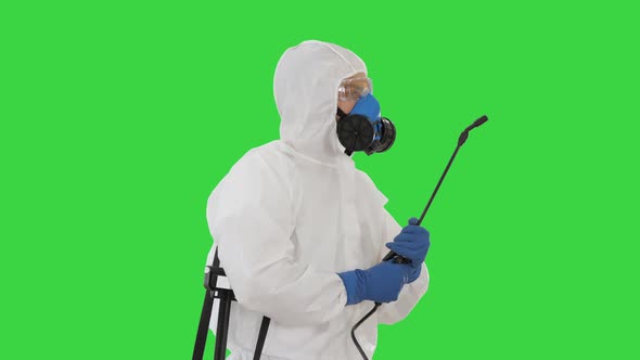 Disinfection For Virus Killing Worker in Hazmat Suit and Face Protection Mask Spraying Using