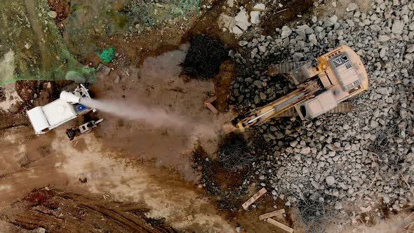 Aerial Overhead Moving Upward View of a Demolition Site with Excavator