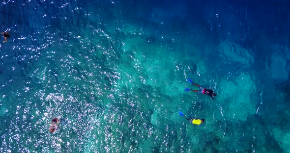 Beautiful drone abstract shot of a sunshine white sandy paradise beach and aqua blue ocean backgroun