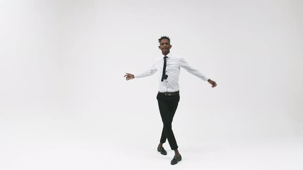 Black Serious Man in an Office Suit Dancing Breakdancing in the Studio