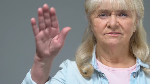 Unhappy Mature Woman Showing Stop Sign, Warning Gesture, Negative Reaction
