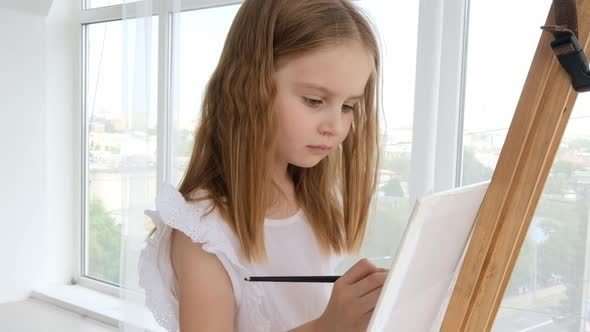 Preteen Girl with Easel at Home