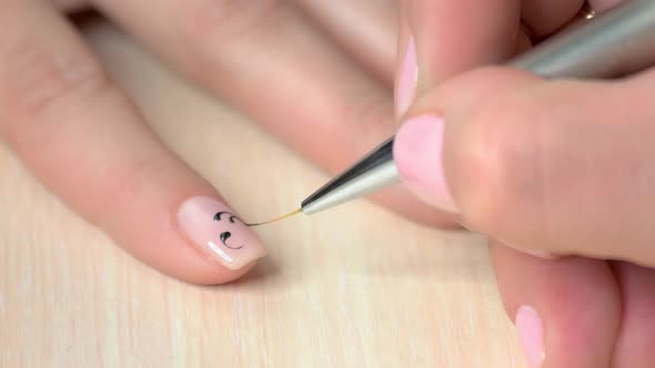 Manicurist Drawing on Female Nails.
