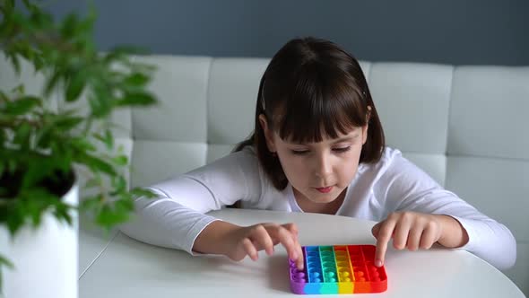 Baby Girl Playing with Rainbow Pop It Fidget