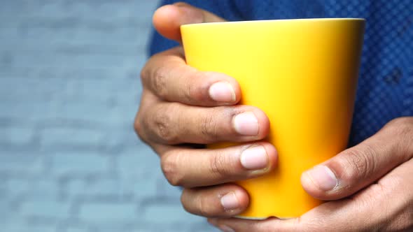 Close Up of Man Hand Holding Mug Isolated on White 