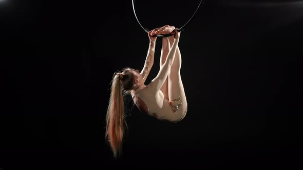 Barefoot Caucasian Slim Woman Hanging on Air Hoop Holding with Feet Spinning