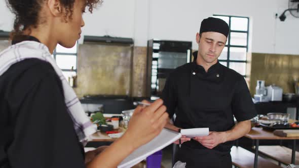 Caucasian female chef teaching diverse group