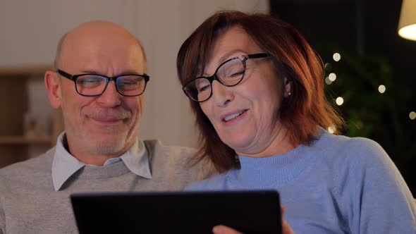 Happy Senior Couple with Tablet Pc at Home