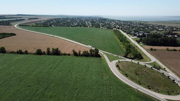 Aerial View of Empty Highway Road Circle Between Meadow and Agricultural Field