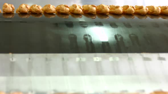 Eclairs Slide Down Conveyor Line