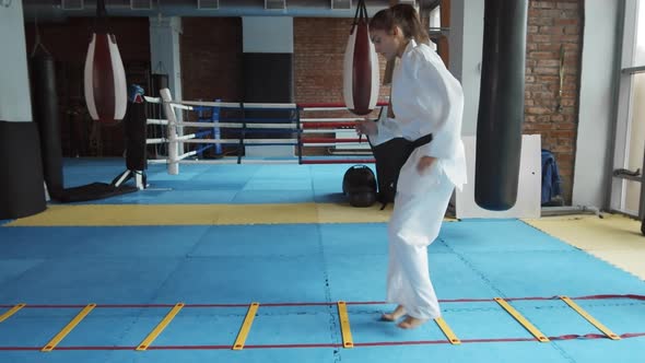 Woman in Kimono Training in Gym