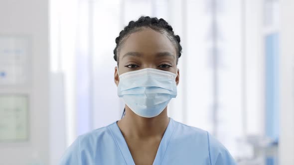 Close Up View of Afro  American Woman in Medical Protective Mask Looking to Camera