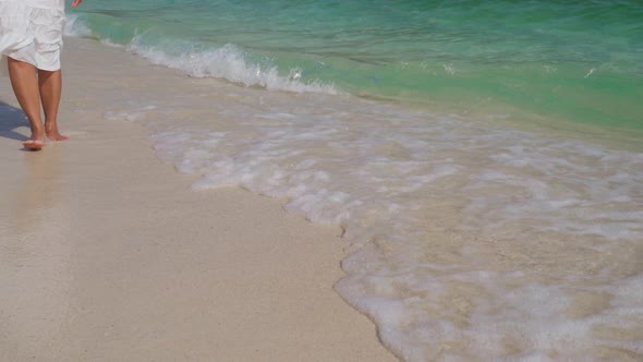 Young woman traveler relaxing and enjoying at beautiful tropical white sand beach