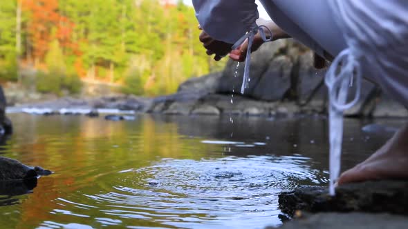 Woman Picking Up Water