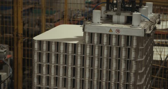 Robotic arm placing canned food for packaging in a warehouse