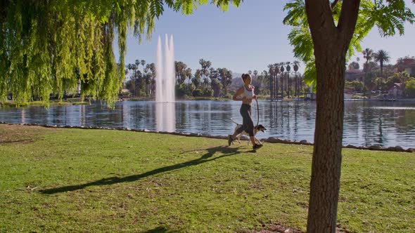 Attractive Woman Jogging With Her Dog