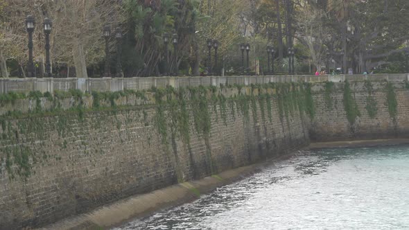 A brick wall by water