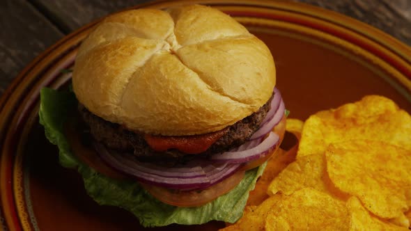 Rotating shot of delicious burger and potato chips - BBQ 160