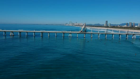 People surfing with the Gold Coast skyline in the foreground