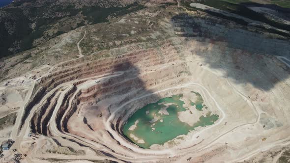 Aerial View Industrial of Opencast Mining Quarry with Lots of Machinery at Work Extracting Fluxes