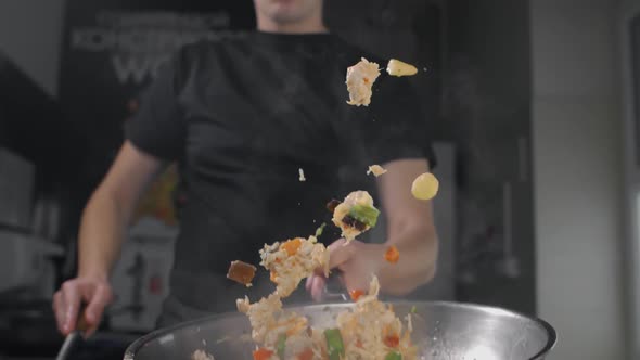 Chef Tosses Fried Vegetables with Noodles in Hot Wok in Slow Motion, Cooking Asian Noodles, Stirring