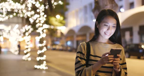 Woman use of smart phone at night