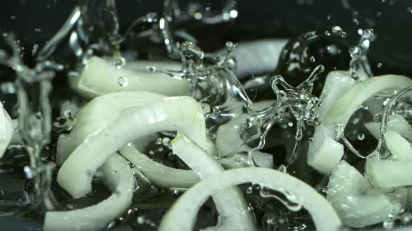 Super Slow Motion Shot of Falling Onion Cuts Into Oil in Pan at 1000 Fps