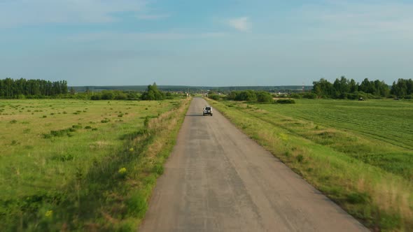 Aerial View of a Car Driving on a Country Road