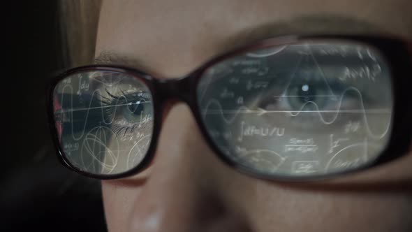 Person Looking at Computer - Data Analysis, Math Formulas Calculation in Reflection of Glasses