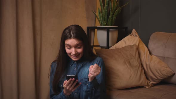 Excited Happy Woman Looking at Phone Screen Celebrating Online Win Holding Smartphone Reading Good