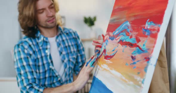 Painter Applying Paints on Big Canvas with Fingers During Creating Abstract picture