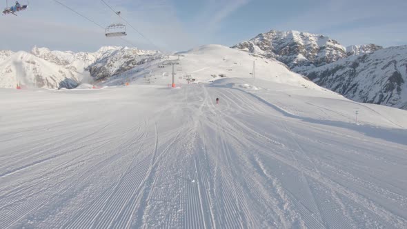 People skiing on snowy slope at ski resort in the mountains