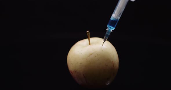 Food Genetic Modification - Syringe Injecting Liquid in Apple